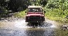 Mike driving his Defender in the river